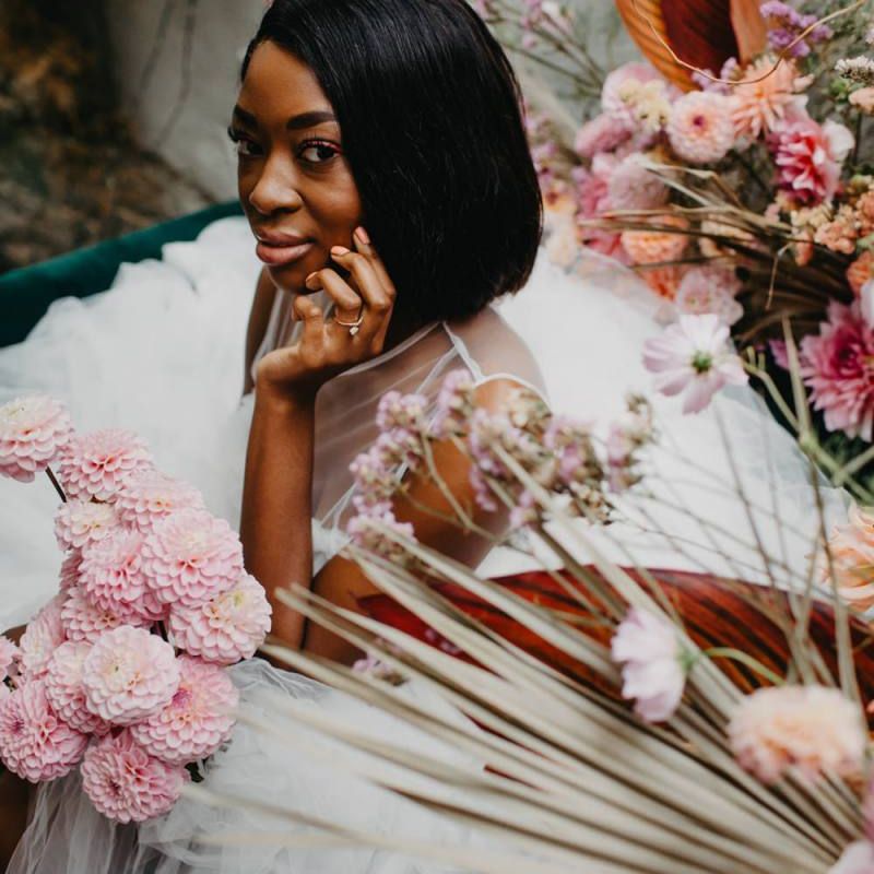 Beautiful bride sitting amongst the flowers