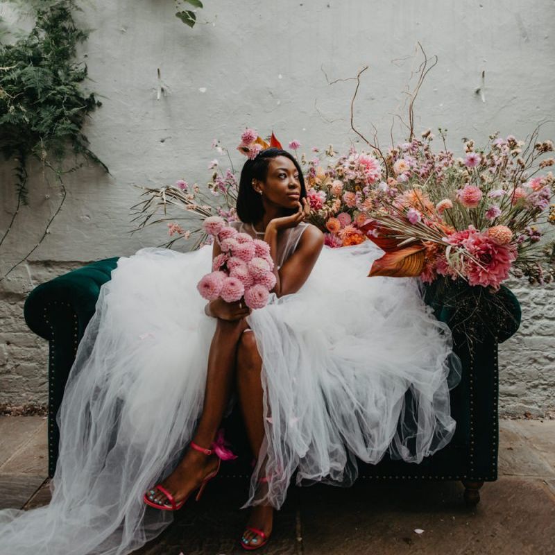 Stunning bride in tulle wedding dress with pompom dahlia wedding bouquet