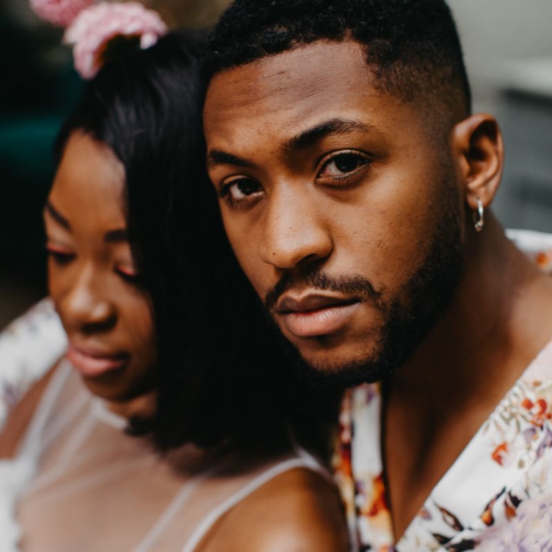 Groom in white floral shirt at tropical wedding