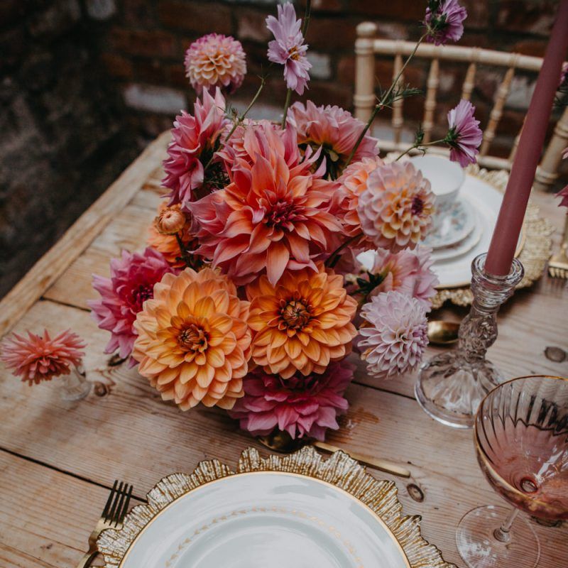 Place setting with gold charger plate and tassel stationery