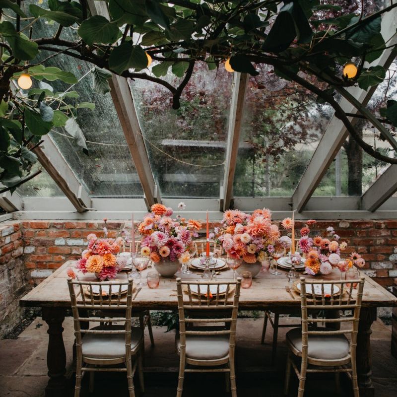 Intimate wedding reception table with floral centrepieces at Secret Garden Kent