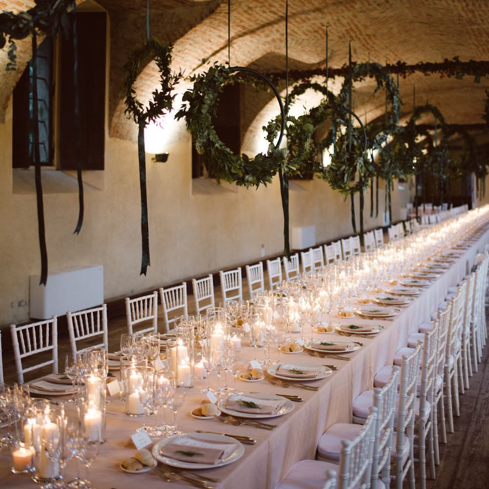 Greenery Hanging Hoops &amp; Candle Light Wedding Reception Decor | Green &amp; White Bohemian Wedding in the Rain at Castello di San Sebastiano da Po, Italy | Margherita Calati Photography | Second Shooter Carlo Vittorio