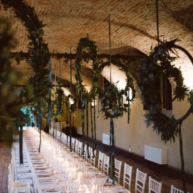 Greenery Hanging Hoops &amp; Candle Light Wedding Reception Decor | Green &amp; White Bohemian Wedding in the Rain at Castello di San Sebastiano da Po, Italy | Margherita Calati Photography | Second Shooter Carlo Vittorio