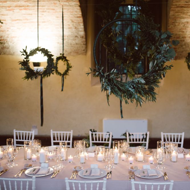 Greenery Hanging Hoops &amp; Candle Light Wedding Reception Decor | Green &amp; White Bohemian Wedding in the Rain at Castello di San Sebastiano da Po, Italy | Margherita Calati Photography | Second Shooter Carlo Vittorio