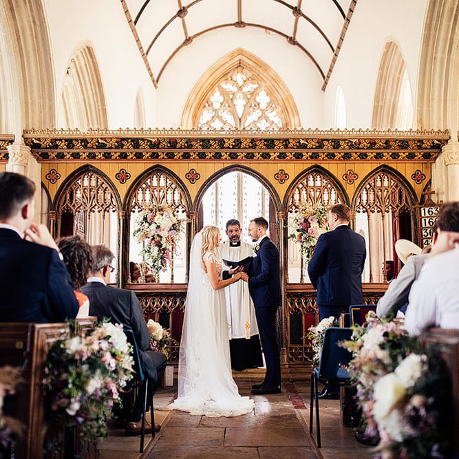 Church wedding ceremony with bride and groom exchanging vows