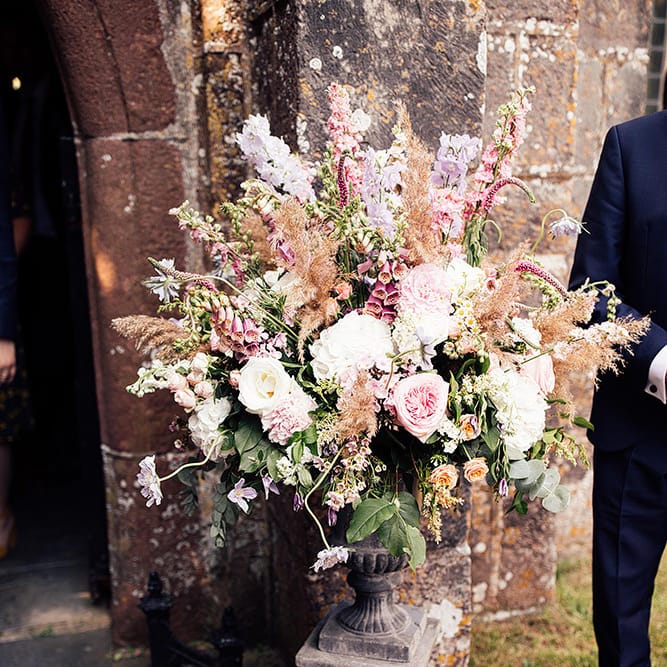 Romantic pink church wedding flower arrangement