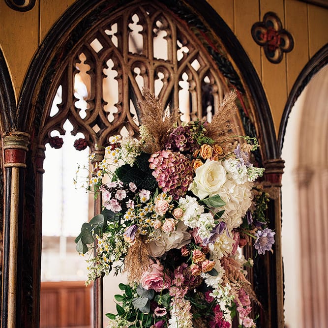 Church altar wedding flowers with pink and white stems for wedding with outdoor first dance