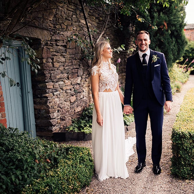 Bride and groom portrait with bride in a Julio Vino wedding dress and groom in navy suit for wedding with outdoor first dance