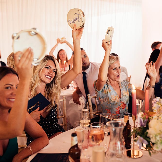 Wedding guests shaking their Tamborine wedding favours