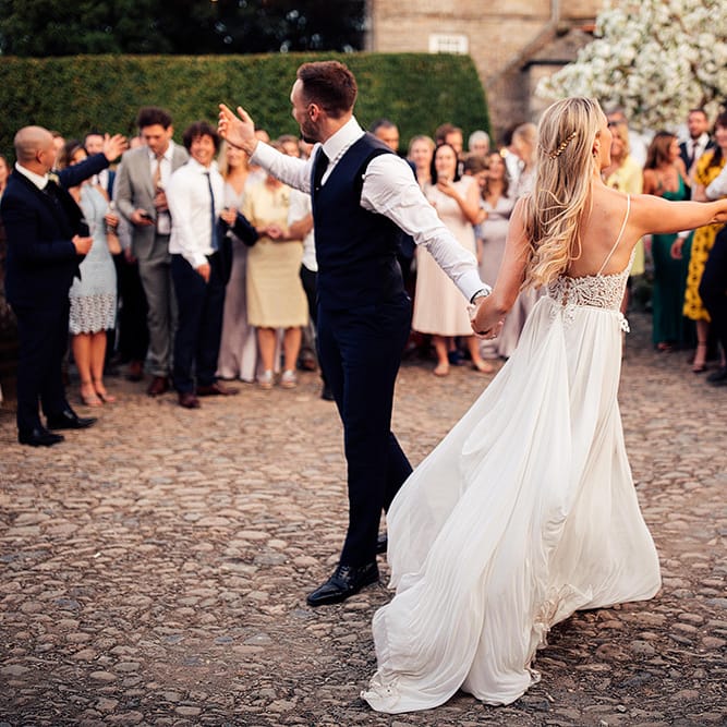 Outdoor wedding first dance with bride in Julio Vino wedding dress