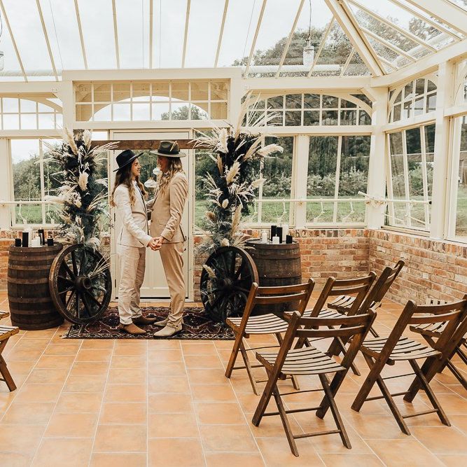 Intimate glasshouse ceremony room with dried pampas grass