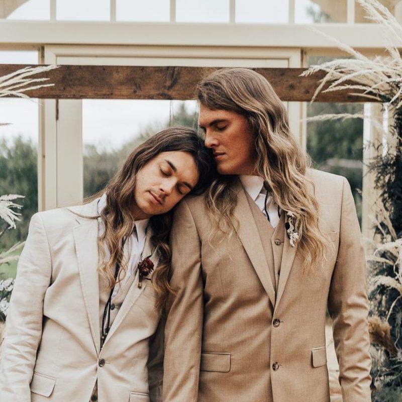Grooms in light stone and beige suits for intimate western wedding