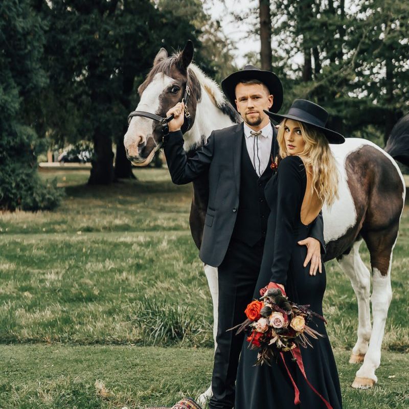 Bride in black wedding dress and hat for western wedding