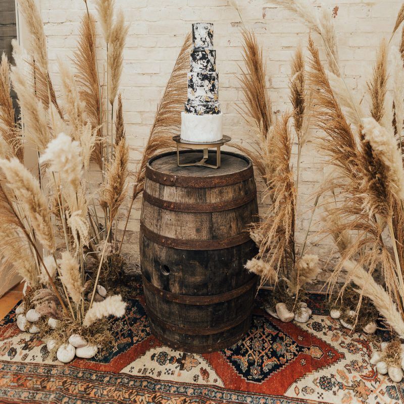 Tall wedding cake on a wooden barrel for western wedding