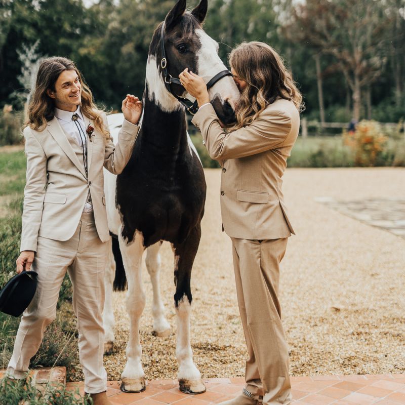 Two grooms with long hair at western wedding
