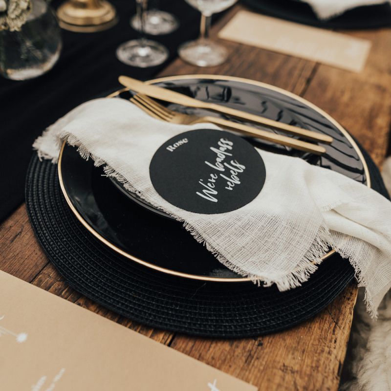 wild west wedding  place setting with black tableware and gold cutlery