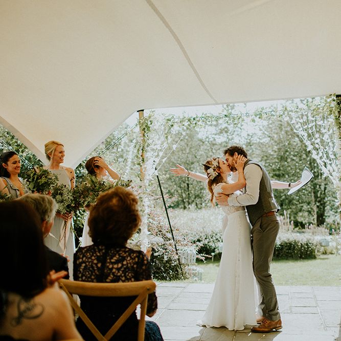 Bride and Groom Kissing at Wedding Ceremony Under a Stretch Tent
