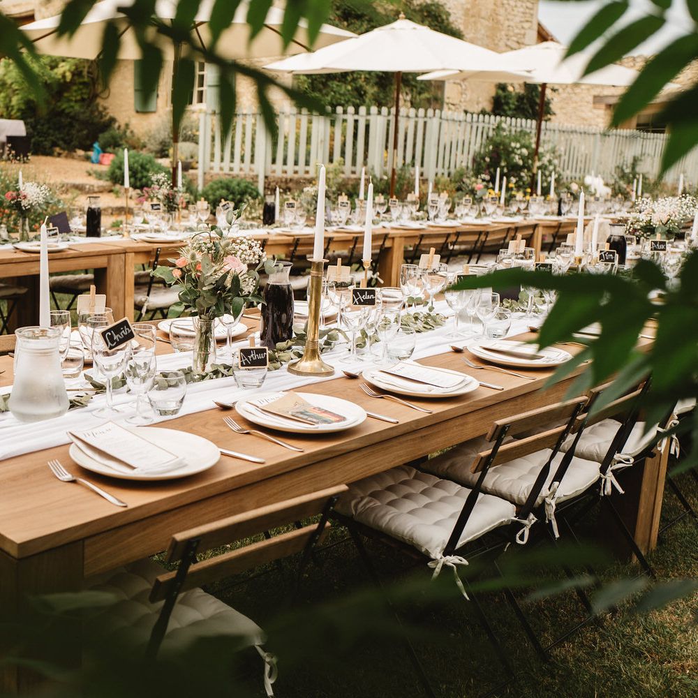 Long Wooden Reception Tables Decorated with Table Runner, Floral Centrepieces and Flowers