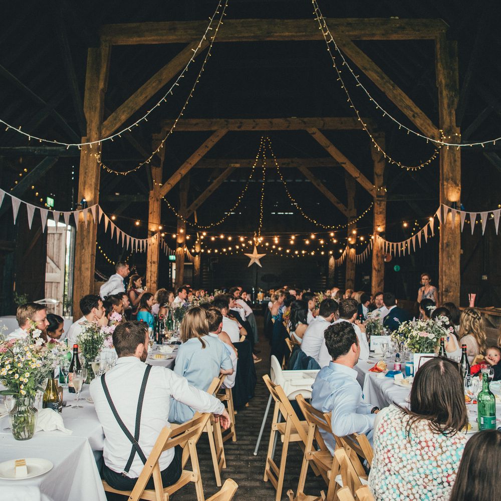 Exclusive Use Barn Wedding Venue with Bunting and Fairy Light Wedding Decor