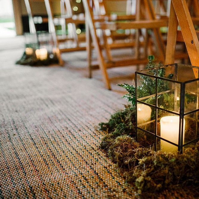 Candles in lanterns aisle decor