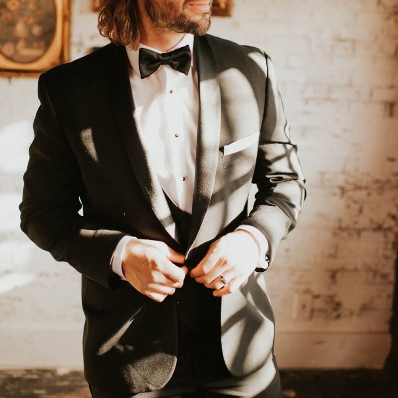 Groom in black tie suit