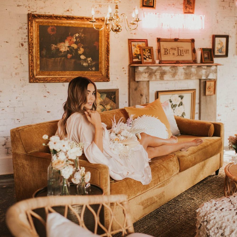 Bride on wedding morning resting on a couch