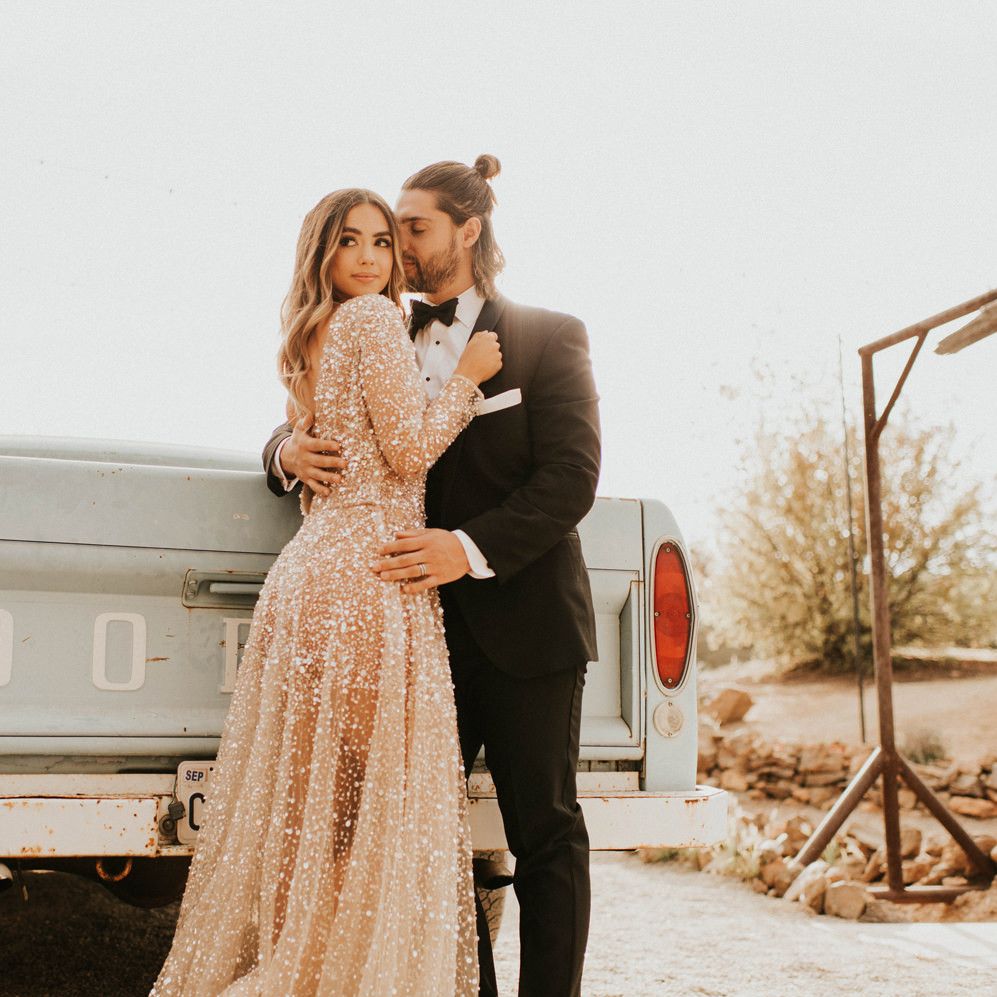 Bride in sparkly wedding dress and groom in tuxedo