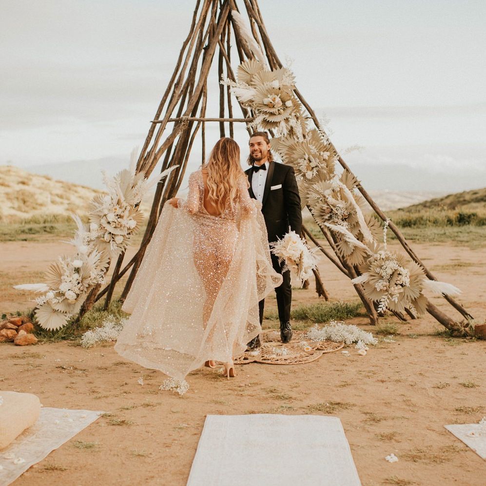 Boho bride in sparkly wedding dress swinging the skirt