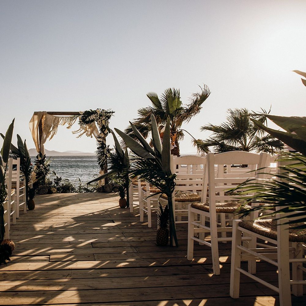 Beautiful Mykonos wedding ceremony with palm decor