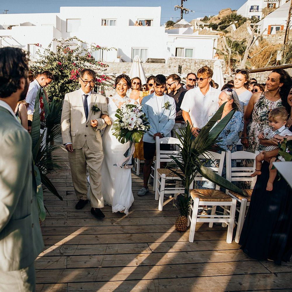 Bride walks down the aisle to meet groom