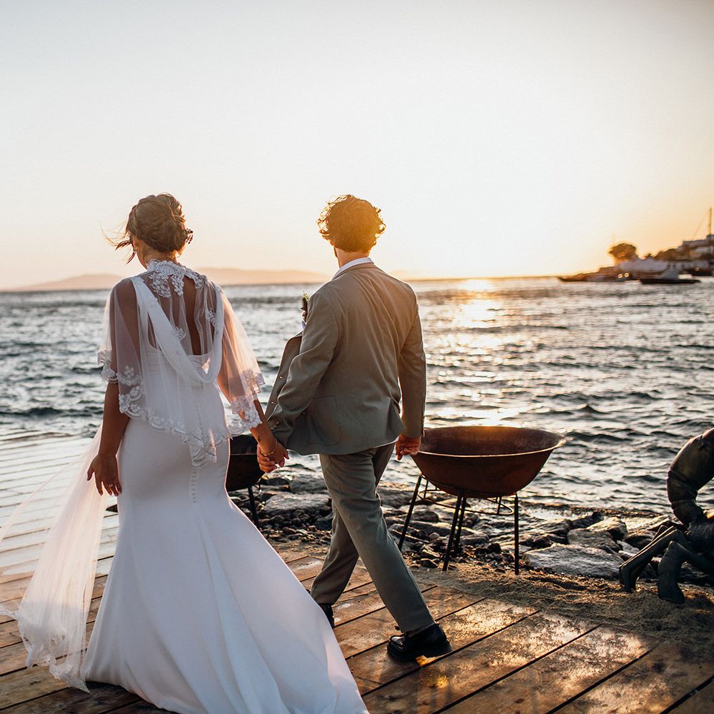 Beautiful bride in lace trim wedding capelet with groom
