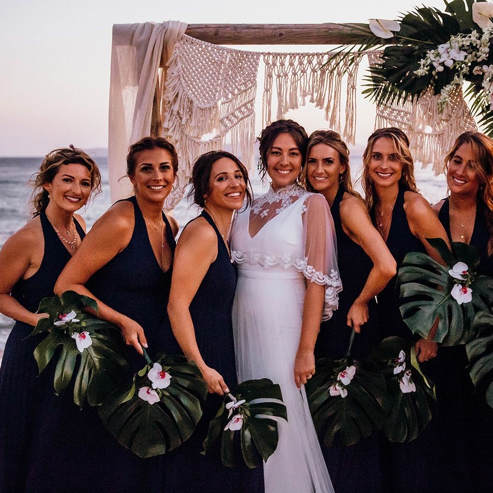Navy blue bridesmaid dresses with palm leaf bouquet