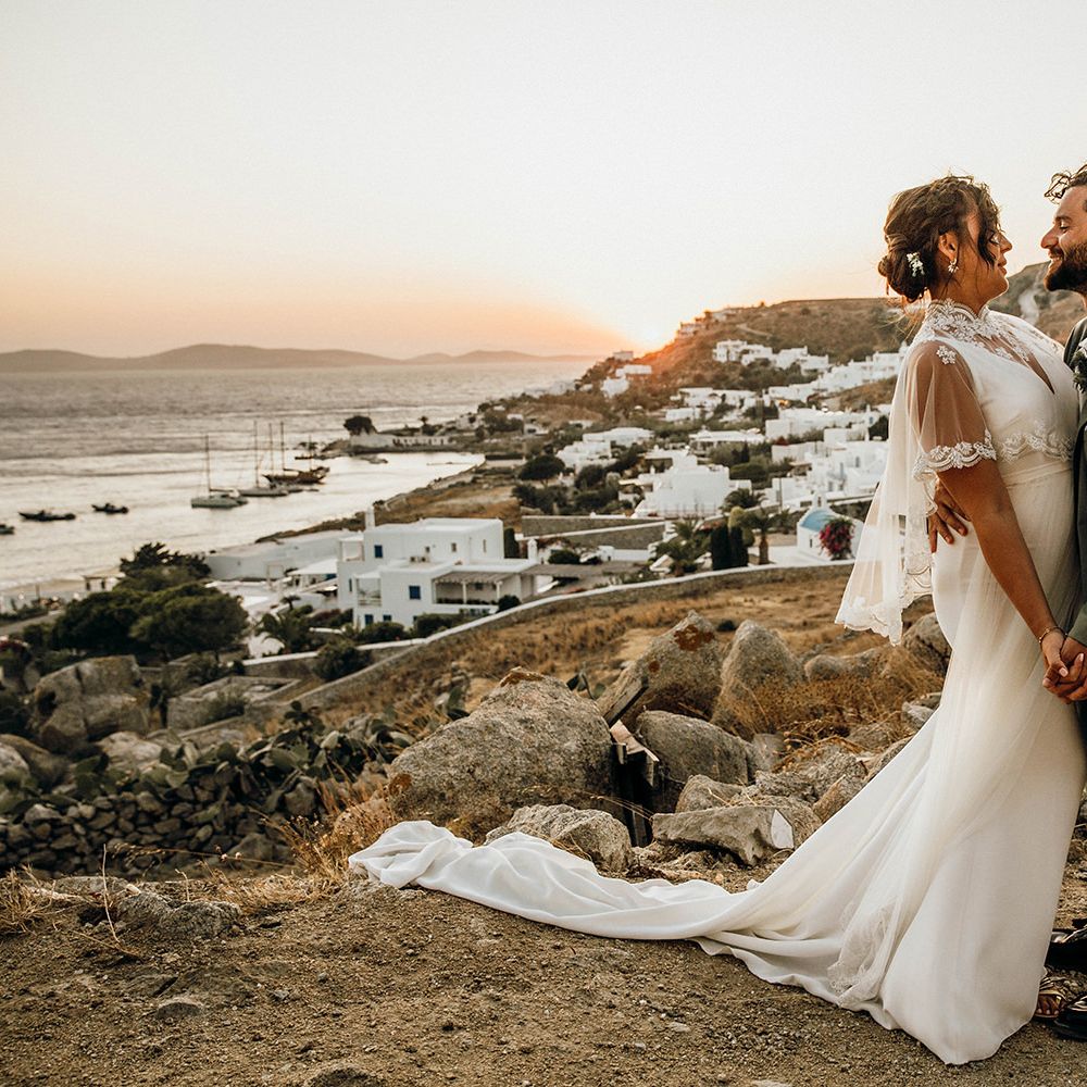 Bride in wedding capelet with groom at Mykonos wedding