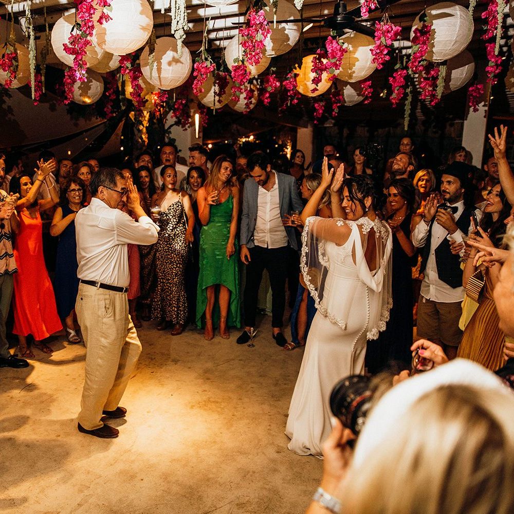 Bride and groom first dance under lanterns and flowers