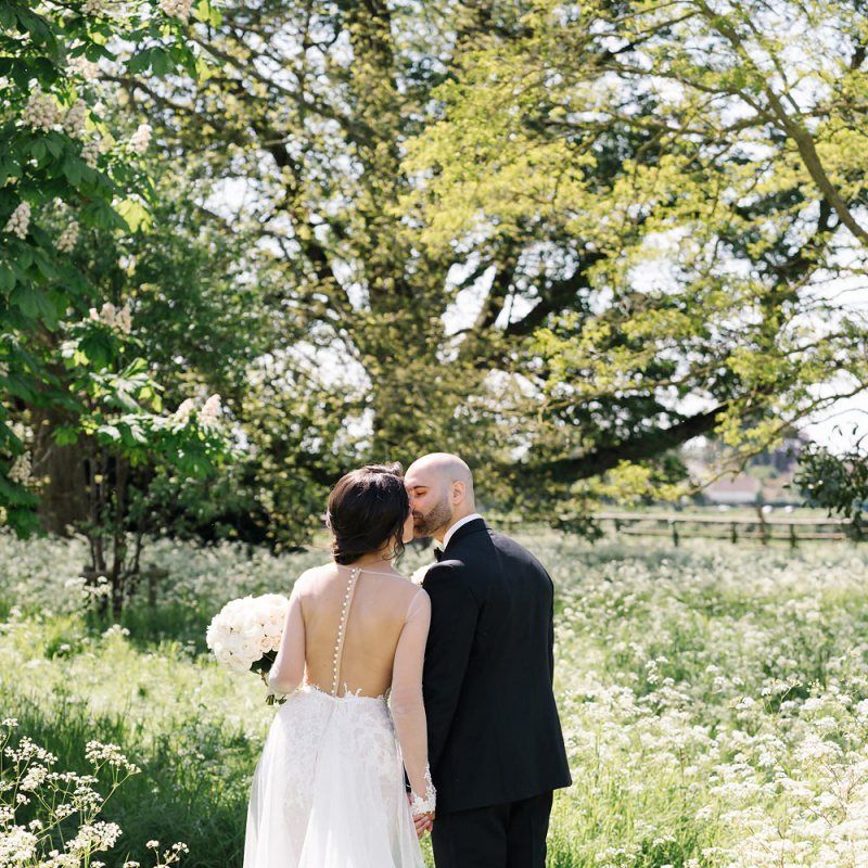 Bride and Groom Kissing in Elmore Court's Gardens
