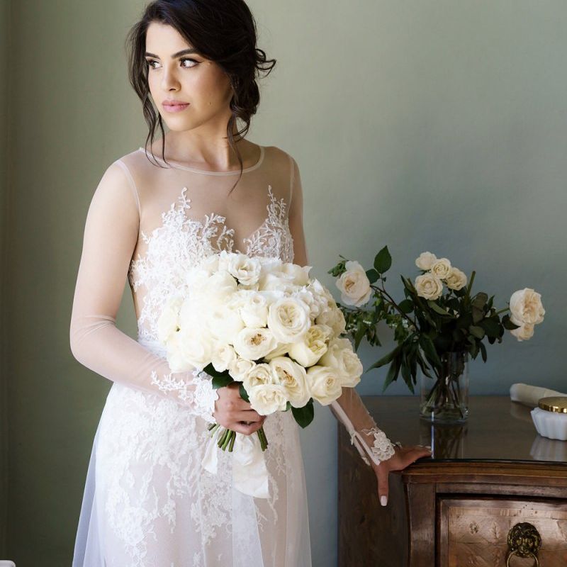 Beautiful Bride in Berta Wedding Dress Holding an All White Rose Wedding Bouquet