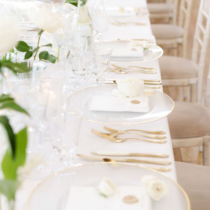 Elegant Place Setting with Glass Gold Rimmed Charger Plates and Gold Cutlery