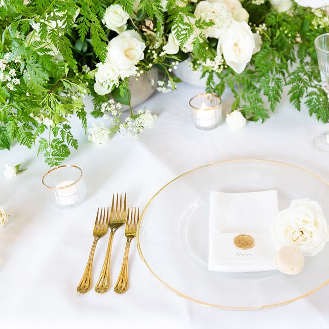 Elegant Place Setting with Gold Rimmed Charger Plates  and Cutlery