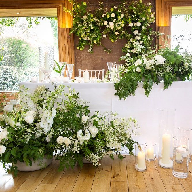 Sweetheart Table with White and Green Wedding Flowers and Lanterns