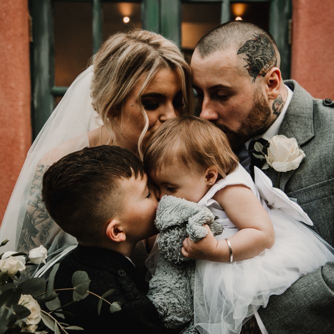 Bride, Groom and Their Children Embracing