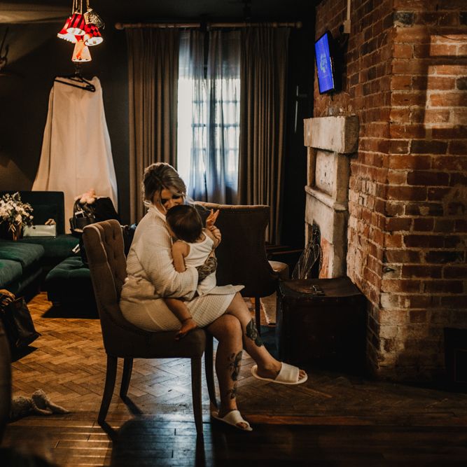 Wedding Morning Bridal Preparations with Bride in Getting Ready Robe Holding Her Daughter