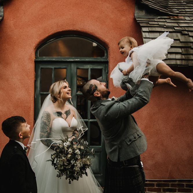 Family Portrait with Tattooed Bride in Essense of Australia Wedding Dress and Groom in Kilt