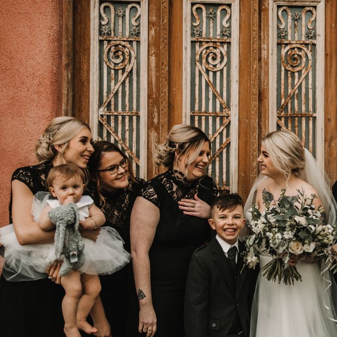 Bridal Party Portrait with Bride in Mermaid Wedding Dress and Bridesmaids in Black Lace Dresses