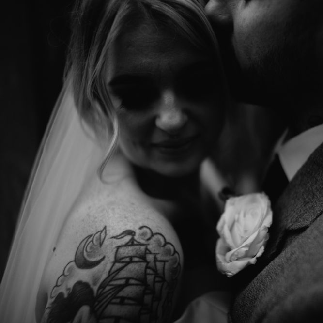 Black and White Portrait of Groom Kissing His Bride