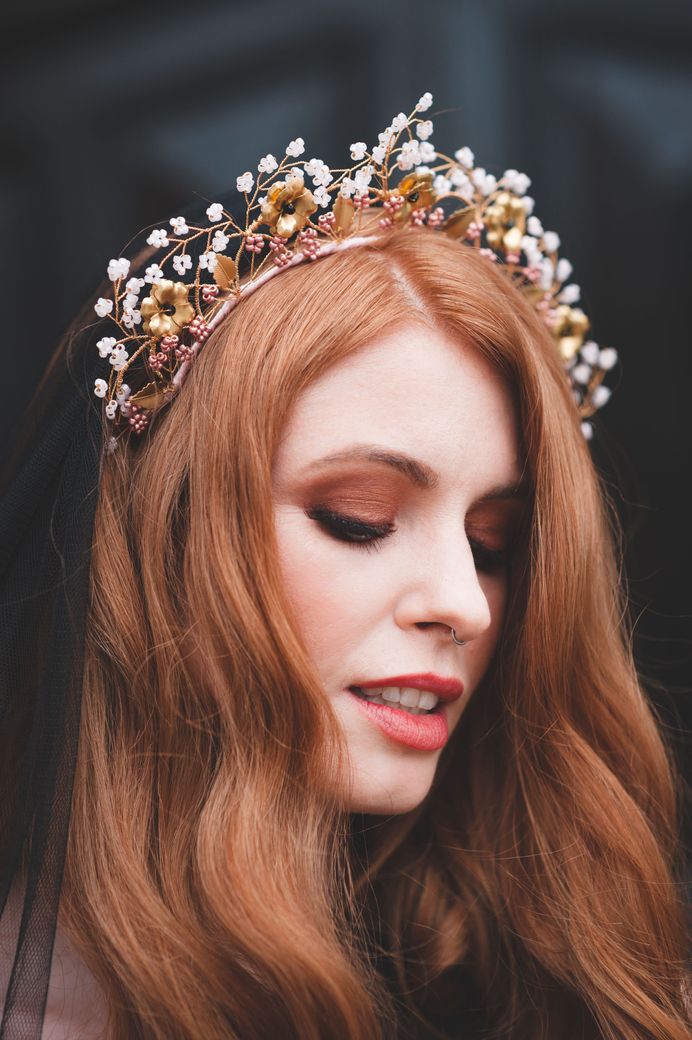 Bride with long auburn hair in a wire headdress with brown eyeshadow and coral lipstick
