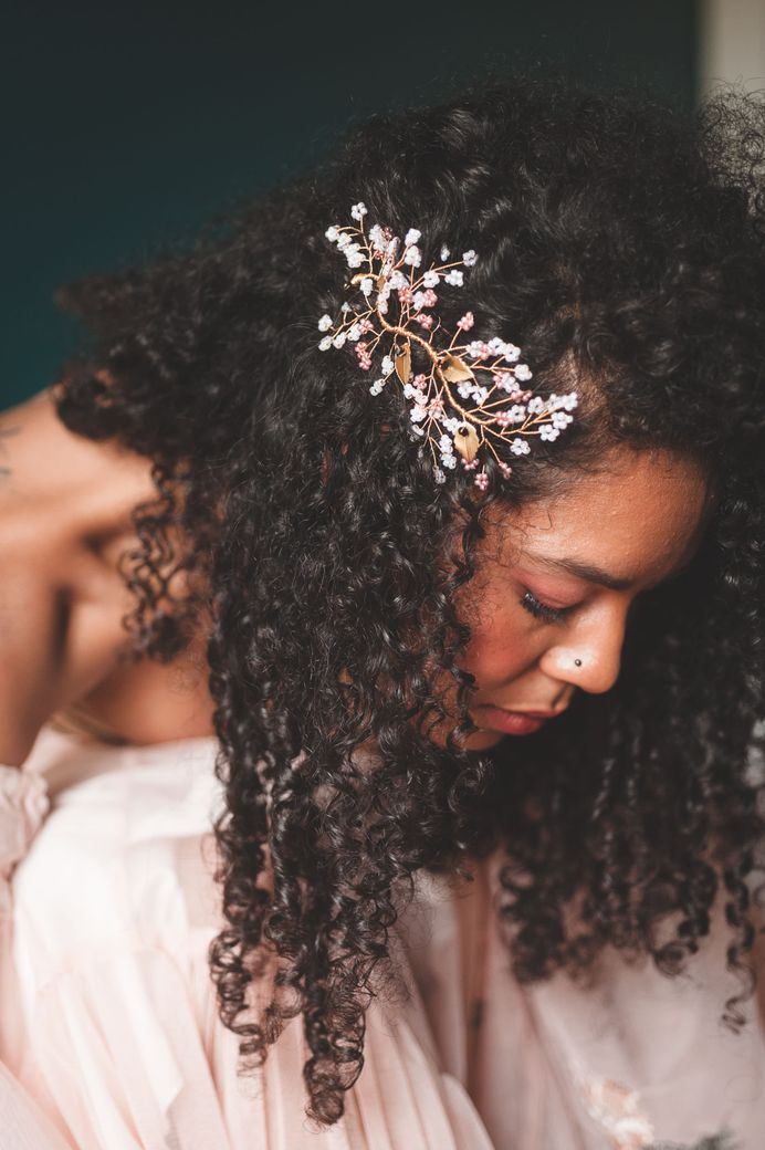black bride with naturally curly hair wearing a wire hair accessory 