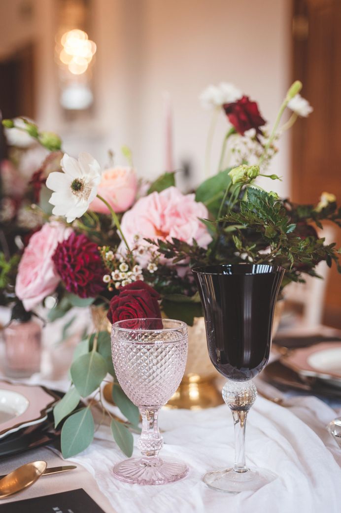Ornate pink and black glass goblets for dramatic Pomegranate Noir wedding inspiration 