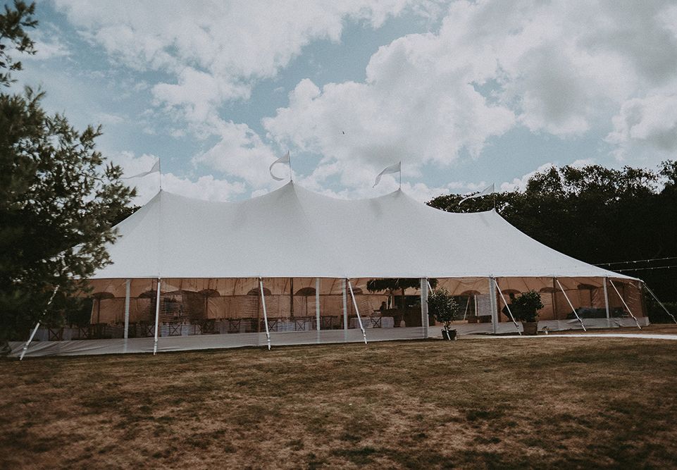 Marquee Wedding at Home on The Isle of Wight with Foliage and Edison