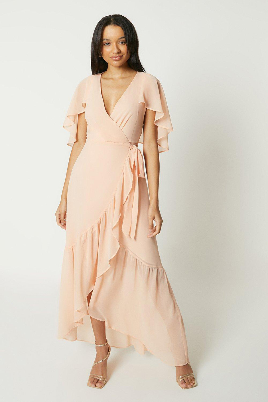 Peach bridesmaid dress with ruffle hem and cape sleeves from Debut London