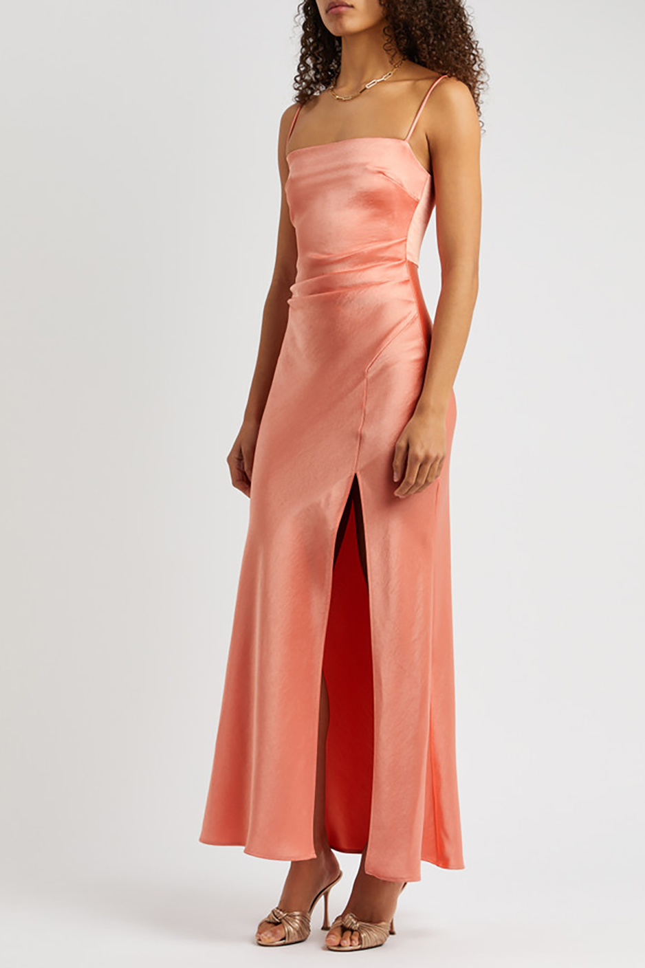 Coral peach bridesmaid dress from Bec & Bridge/ Harvey Nichols with maxi satin design and leg split 